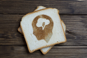 toast with the sign of mental activity on dark wood.