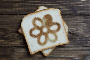toast with a flower sign on dark wood.
