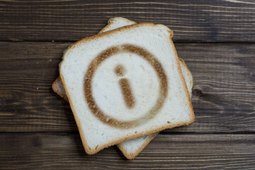 toast with information sign on dark wood.