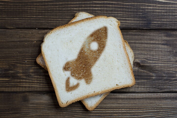 toast with rocket sign on dark wood.