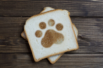 toast with a footprint sign on dark wood.
