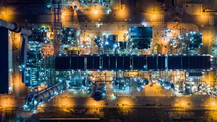 Oil refinery plant from industry zone, Aerial view oil and gas petrochemical industrial, Refinery factory oil storage tank and pipeline steel at night, Ecosystem and healthy environment concepts.