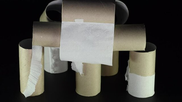 A structure of empty toilet paper sleeves blown by the wind. Concept of scarcity of basic necessities during a crisis or pandemic.