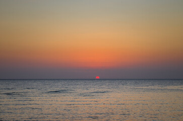 Beautiful sunrise at sea. Dawn on the Red Sea. The sun is reflec