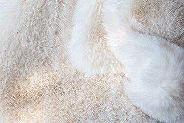 Close-up white fur background with abstract glowing sunlight shadows.