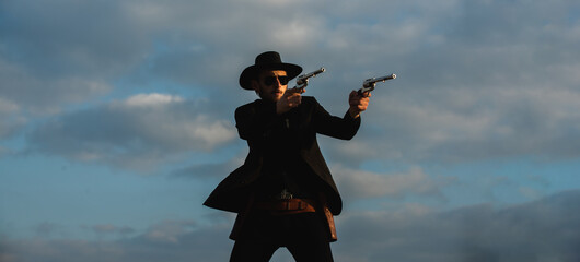 American cowboy shooting. Handsome brutal western guy. Sheriff with wild west guns, vintage pistol...