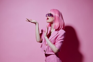 Portrait of a charming lady gestures with his hands with a pink jacket unaltered