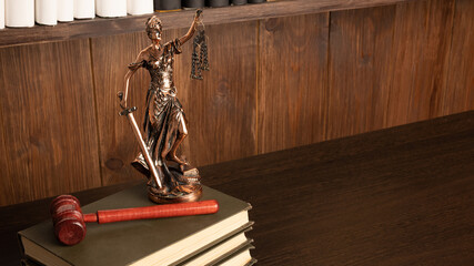 Lady Justice, Judge's gavel, books on an old wooden table
