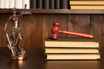 Lady Justice, Judge's gavel, books on an old wooden table