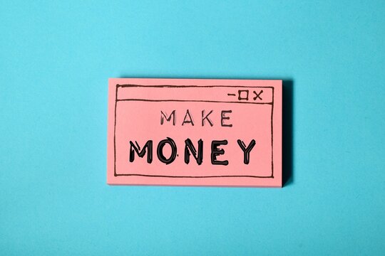 Make money inscription on hand drawn web browser window on blue background. Earning money online concept. 