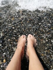 Woman's Feet on the Pebble Beach