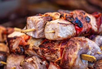 Pile of pork skewers on display at a street food festival in Romania.