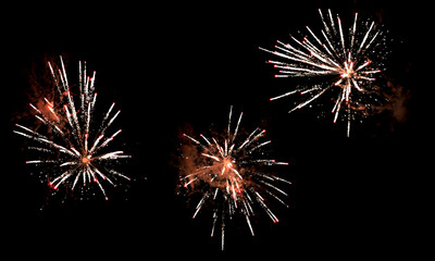 Textures of festive fireworks and bright particles on a black background - 477936074