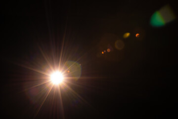 Fototapeta na wymiar Sun flare on the black background