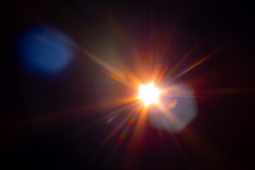 Fototapeta na wymiar Sun flare on the black background