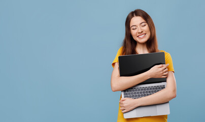 Emotional young woman enjoying her new modern laptop