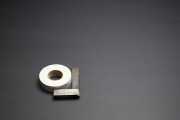 the square tool is leaned against a coil of duct tape. space for printing text.