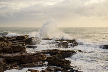 Waves crashing onto rocks located in Margate South Africa