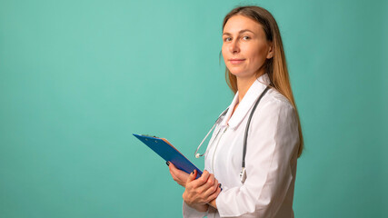 Young attractive woman nurse or doctor in a white coat with file on background