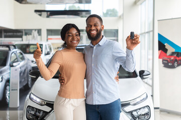 Happy Black Couple Holding Keys From New Car And Showing Thumb Up