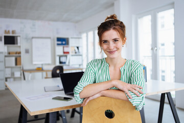 Relaxed young office worker with a sweet smile