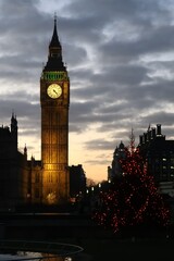 The Westminster Palace and Big Ben clock tower, major tourist attraction and Parliament in London just after sunset.