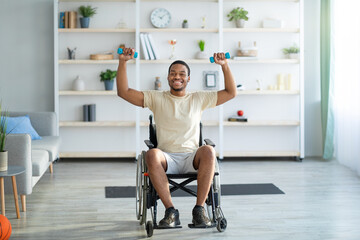 Fototapeta premium Rehab exercises for disabled people. Paraplegic black guy in wheelchair working out with dumbbells at home, full length