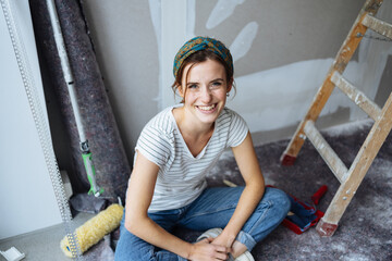 Pretty young woman resting during DIY renovations on her home