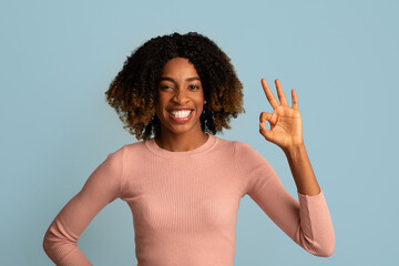 Cheerful Young African American Woman Showing Ok Gesture At Camera
