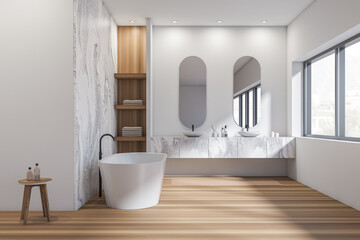 Obraz na płótnie Canvas Bright bathroom interior with two sinks, bathtub, oval mirrors, window