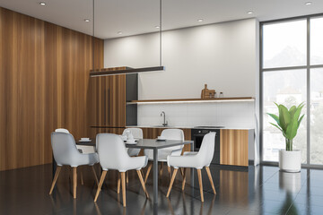 White and wooden kitchen set interior with dining table and chairs, window