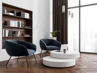 Corner view on bright meeting room interior with two armchairs