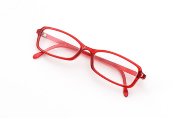 Red eyeglasses on the white background.