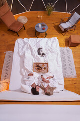 Married couple having a romantic dinner in bed