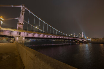 Fototapeta premium Crimean bridge in the fog at night. Night city. Steel suspension bridge in Moscow.
