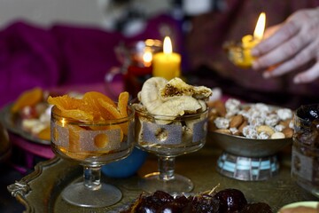 Black Turkish tea in lale with oriental sweets and dried fruits by candlelight 