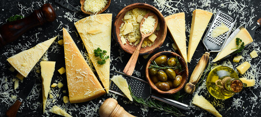 Fototapeta Piece of Parmesan cheese and cheese knife. On a stone background. Traditional Italian cheese. Top view. Free space for your text. obraz