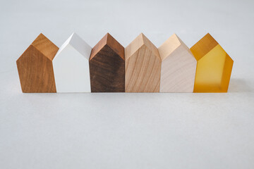Set of tiny wooden houses in a row. Detached wooden houses in a diverse neighborhood.