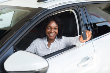 Happy African American Woman Showing Keys Of Her Automobile Out Of Window