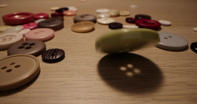 Button for sewing. Button spin on the table. Concept of extreme macro of tailoring and sewing.