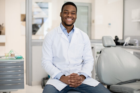 Dental Services. Professional Black Male Stomatologist Posing At Workplace In Clinic Interior