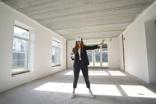 Woman in VR headset in the middle of empty room