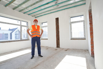 Housebuilder staring at ceiling of room under construction