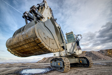 Big excavator in coal mine at cloudy day, low angle view © photollurg