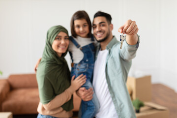 Fototapeta premium Happy middle eastern family showing keys of their apartment
