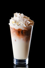 Glass of coffee with ice and whipped cream isolated on black
