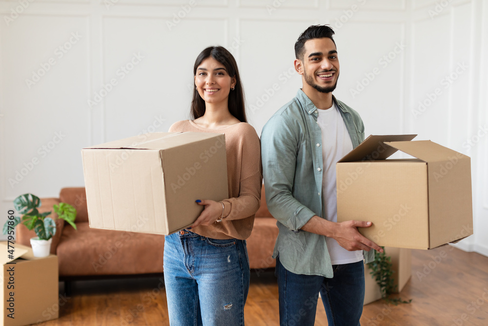 Poster happy man and woman holding cardboard boxes