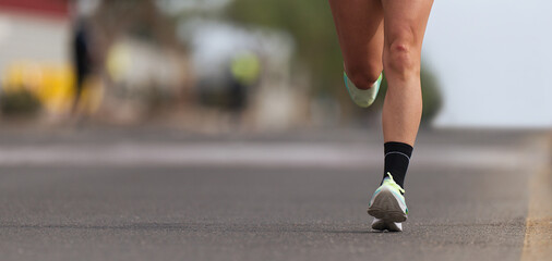 Athlete runner feet running on road close up on shoe , marathon running race