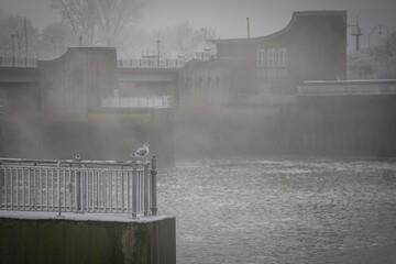 Bremen, Germany. First hoarfrost at Weserwehr weir next to swb Stadtwerke power plant beneath Weser...