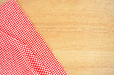 Fototapeta premium Classic pink plaid fabric or tablecloth in the corner of wood desk with copy space